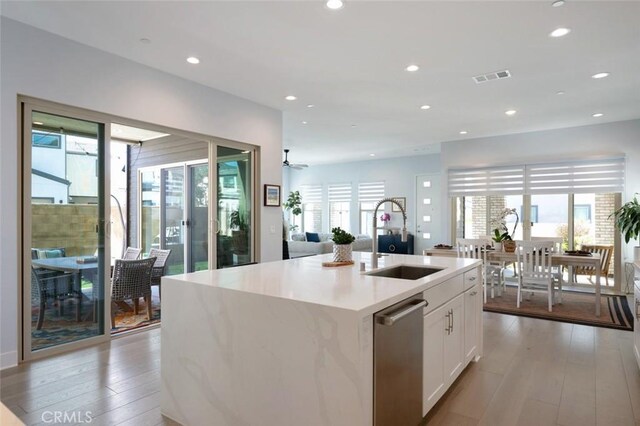 135 Bosal, Irvine, CA 92618 - kitchen with a sink, healthy amount of natural light, white cabinets, light wood-style flooring, and recessed lighting