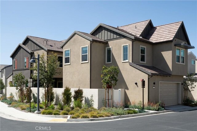 135 Bosal, Irvine, CA 92618 - view of home's exterior featuring stucco siding, a garage, and board and batten siding