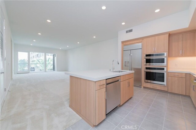1406 Rivington, Irvine, CA 92612 - kitchen with light brown cabinets, light carpet, recessed lighting, stainless steel appliances, and a sink