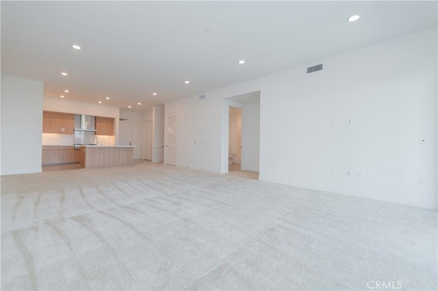 1406 Rivington, Irvine, CA 92612 - unfurnished living room featuring light carpet, visible vents, and recessed lighting