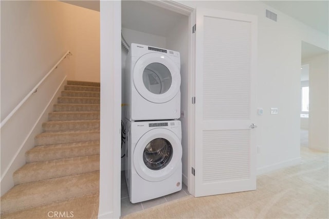 1406 Rivington, Irvine, CA 92612 - clothes washing area with tile patterned floors, visible vents, stacked washer and clothes dryer, and laundry area