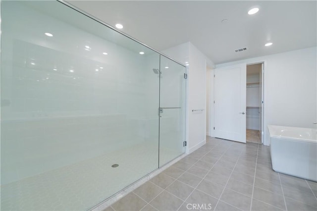 1406 Rivington, Irvine, CA 92612 - full bathroom with visible vents, a freestanding tub, tile patterned flooring, a shower stall, and a walk in closet