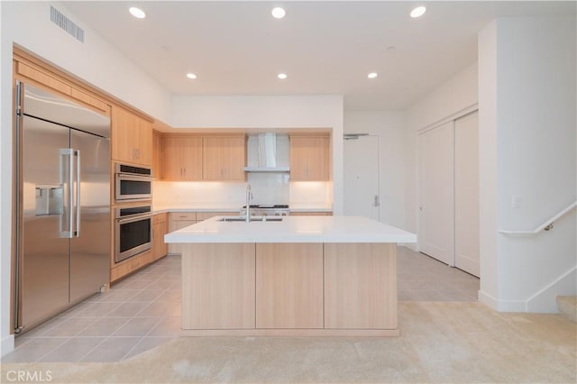 1406 Rivington, Irvine, CA 92612 - kitchen featuring visible vents, light brown cabinetry, light countertops, appliances with stainless steel finishes, and wall chimney range hood