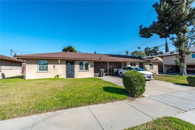 ranch-style home with fence, concrete driveway, a front yard, stucco siding, and a garage