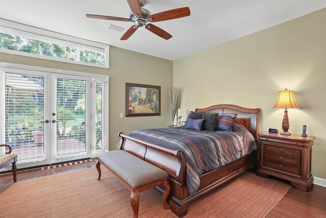 bedroom with access to exterior, visible vents, french doors, wood finished floors, and a ceiling fan