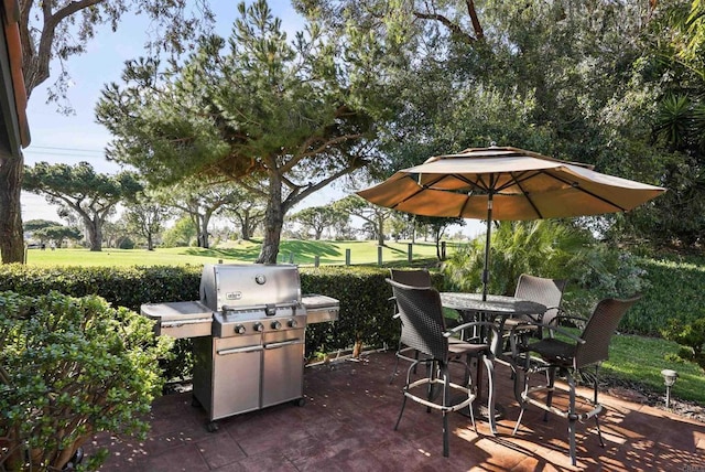 view of patio featuring outdoor dining area, area for grilling, and fence