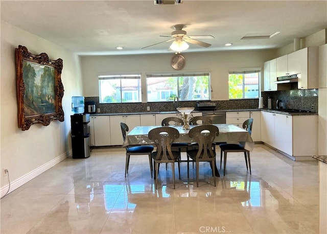 dining space with visible vents, baseboards, and a ceiling fan