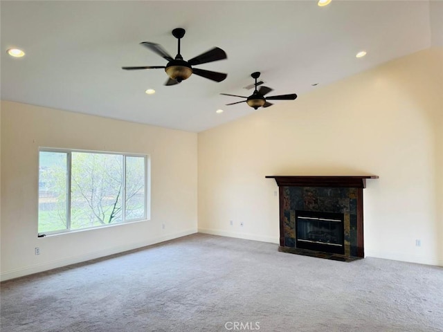 unfurnished living room featuring lofted ceiling, carpet, baseboards, and ceiling fan