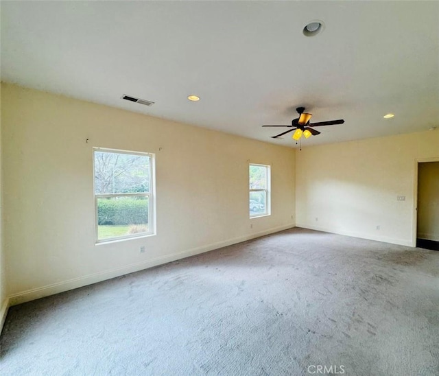 unfurnished room with visible vents, recessed lighting, carpet flooring, baseboards, and ceiling fan