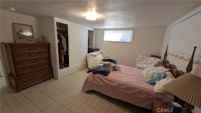 bedroom featuring a closet and light floors