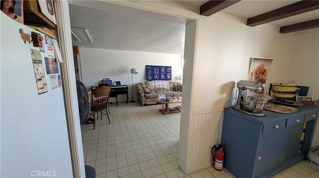 interior space with beamed ceiling and wainscoting