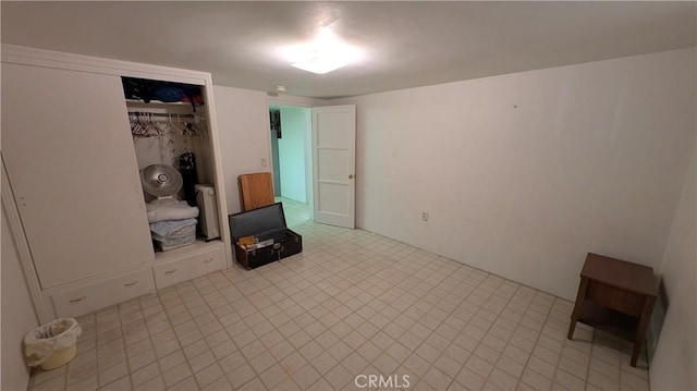 interior space featuring a closet, light floors, and radiator