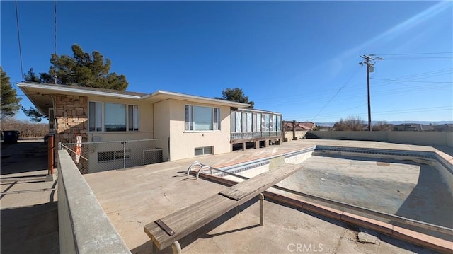 exterior space featuring fence, stucco siding, a patio, and a fenced in pool