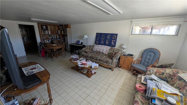 living room featuring tile patterned floors and attic access