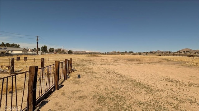 view of yard featuring fence and a rural view