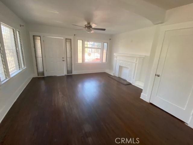 3030 W 12th Pl, Los Angeles, CA 90006 - unfurnished living room with baseboards, a ceiling fan, dark wood-type flooring, and a fireplace