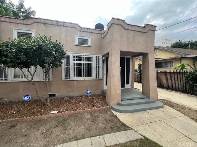 3030 W 12th Pl, Los Angeles, CA 90006 - mediterranean / spanish house featuring stucco siding and fence