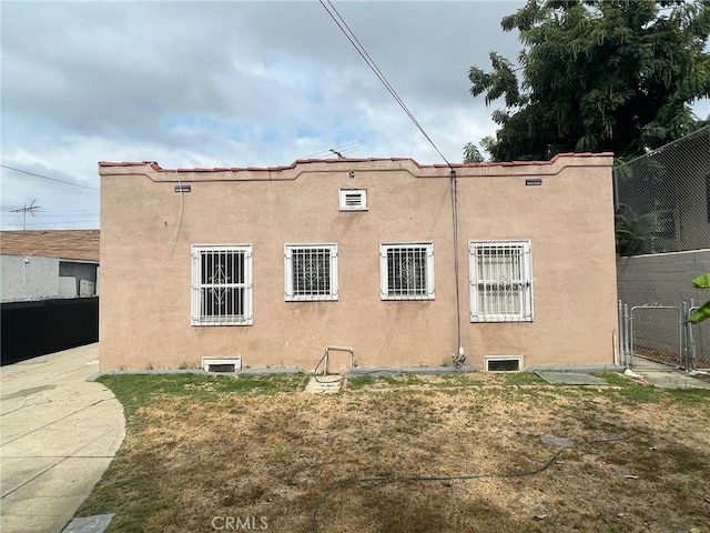 3030 W 12th Pl, Los Angeles, CA 90006 - view of side of property with fence, a gate, and stucco siding