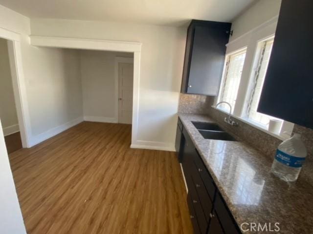 3030 W 12th Pl, Los Angeles, CA 90006 - kitchen featuring a sink, tasteful backsplash, baseboards, wood finished floors, and light stone counters