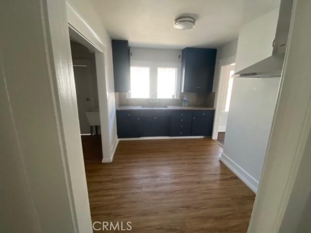 3030 W 12th Pl, Los Angeles, CA 90006 - hallway with baseboards and dark wood-type flooring