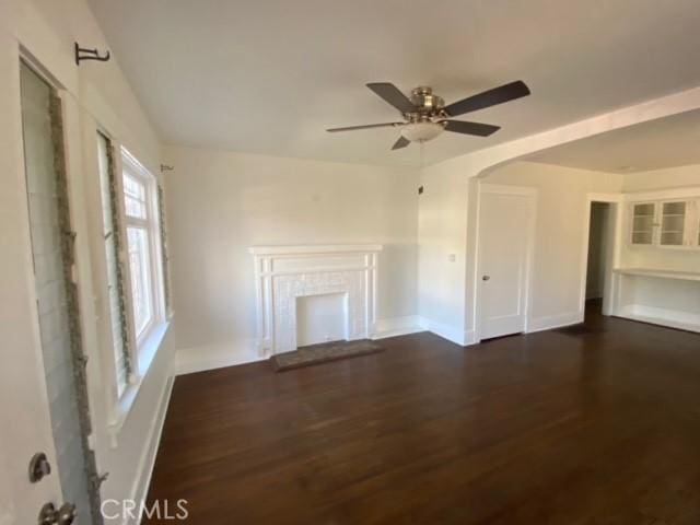 3030 W 12th Pl, Los Angeles, CA 90006 - unfurnished living room featuring baseboards, a ceiling fan, and wood finished floors