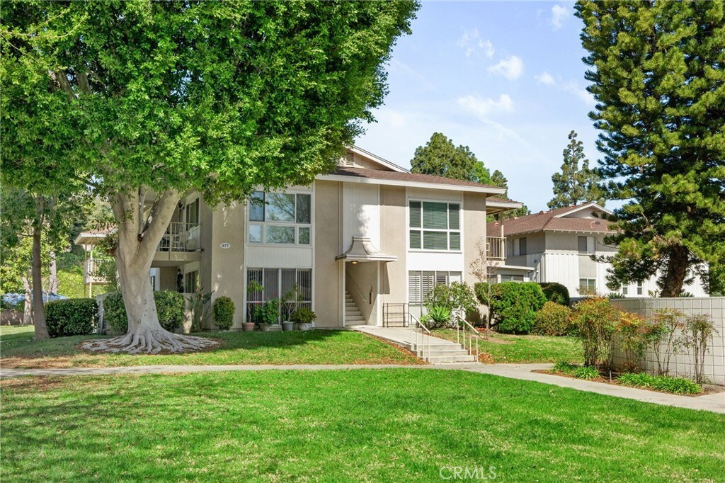 view of property featuring stucco siding and a front yard