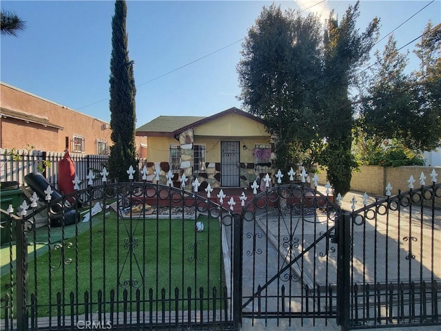 5510 S San Pedro St, Los Angeles, CA 90011 - view of front of home featuring a front yard, a fenced front yard, and stucco siding