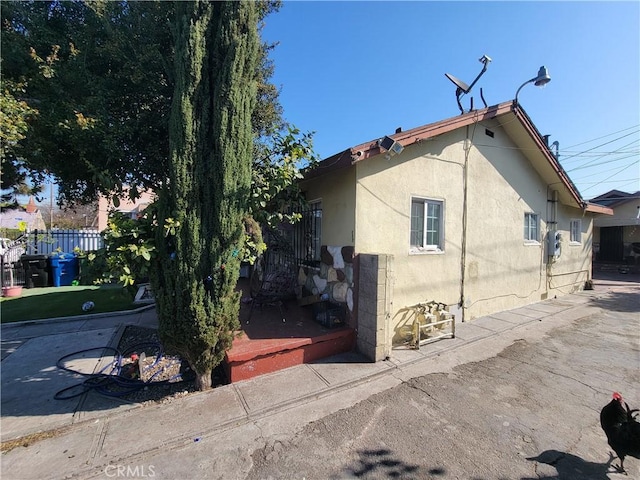 5510 S San Pedro St, Los Angeles, CA 90011 - view of home's exterior featuring stucco siding and fence