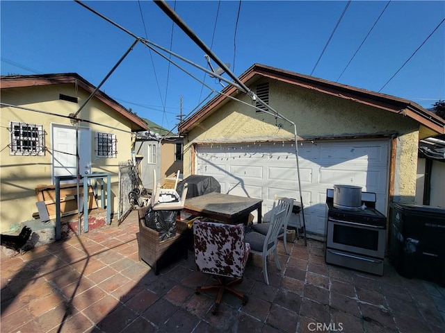 5510 S San Pedro St, Los Angeles, CA 90011 - view of patio featuring grilling area and a garage