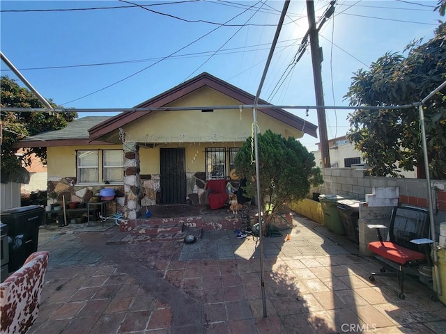 5510 S San Pedro St, Los Angeles, CA 90011 - exterior space with stucco siding, fence, a patio, and stone siding