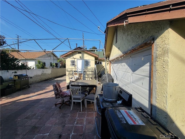 5510 S San Pedro St, Los Angeles, CA 90011 - view of patio featuring outdoor dining area, an outbuilding, fence, and a garage