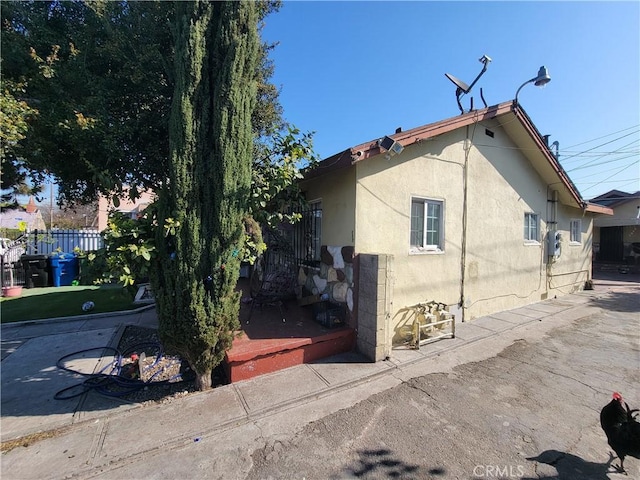 5510 S San Pedro St, Los Angeles, CA 90011 - view of home's exterior featuring stucco siding and fence