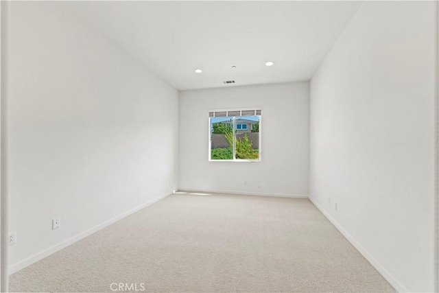 unfurnished room with light carpet, baseboards, visible vents, and recessed lighting