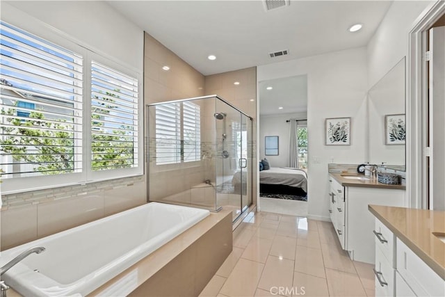 ensuite bathroom featuring vanity, visible vents, tile patterned flooring, a shower stall, and a bath