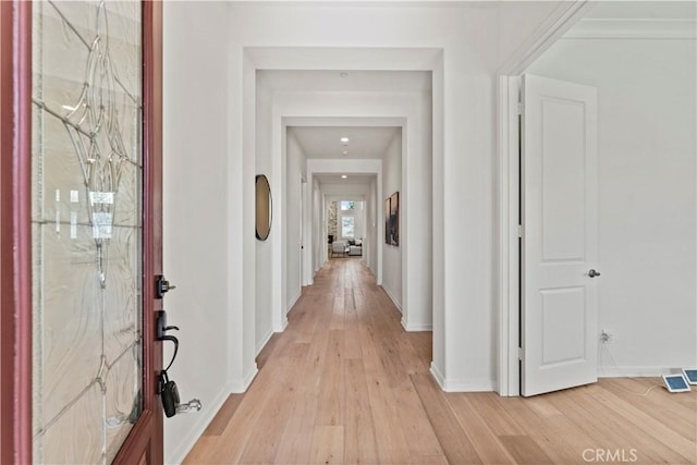 entryway with baseboards and light wood-type flooring