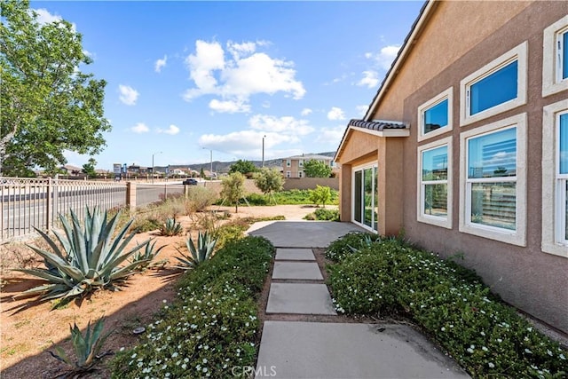 view of yard featuring fence and a patio
