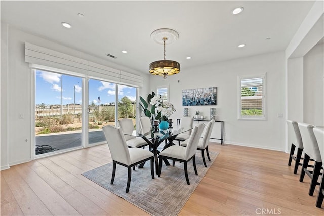 dining space featuring plenty of natural light, light wood-style flooring, and recessed lighting