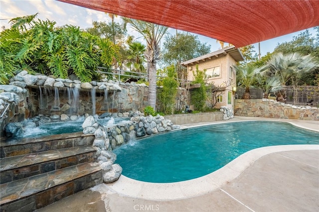 view of swimming pool featuring a fenced in pool and fence