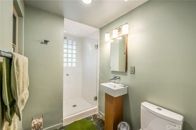 bathroom with vanity, toilet, and a stall shower