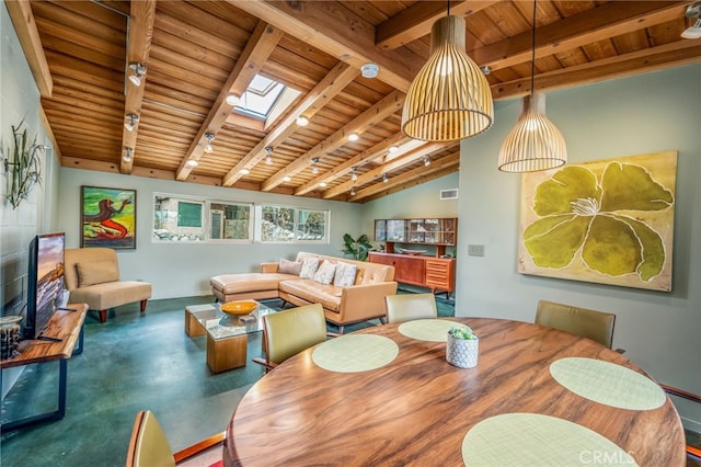 dining area featuring visible vents, lofted ceiling with skylight, concrete flooring, track lighting, and wood ceiling