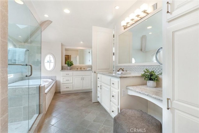129 Via Waziers, Newport Beach, CA 92663 - bathroom featuring vanity, a stall shower, a garden tub, backsplash, and recessed lighting