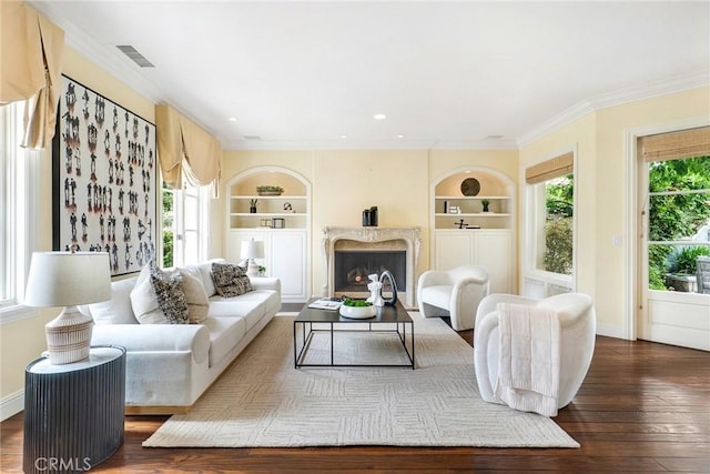 129 Via Waziers, Newport Beach, CA 92663 - living room featuring healthy amount of natural light, built in features, hardwood / wood-style flooring, ornamental molding, and recessed lighting