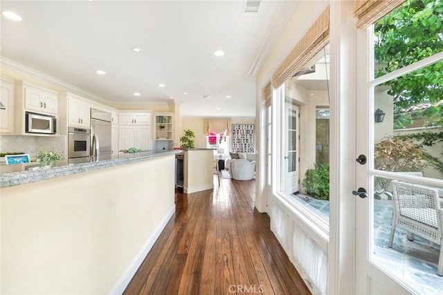 129 Via Waziers, Newport Beach, CA 92663 - hall featuring healthy amount of natural light, dark wood-type flooring, recessed lighting, and crown molding