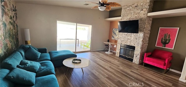 15781 Coral St, Palm Springs, CA 92262 - living room with a stone fireplace, ceiling fan, and wood finished floors