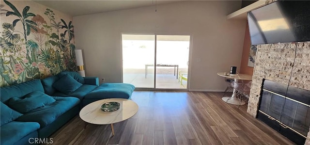 15781 Coral St, Palm Springs, CA 92262 - living room featuring wood finished floors, a fireplace, and vaulted ceiling