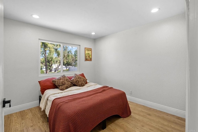 bedroom featuring recessed lighting, baseboards, and light wood finished floors