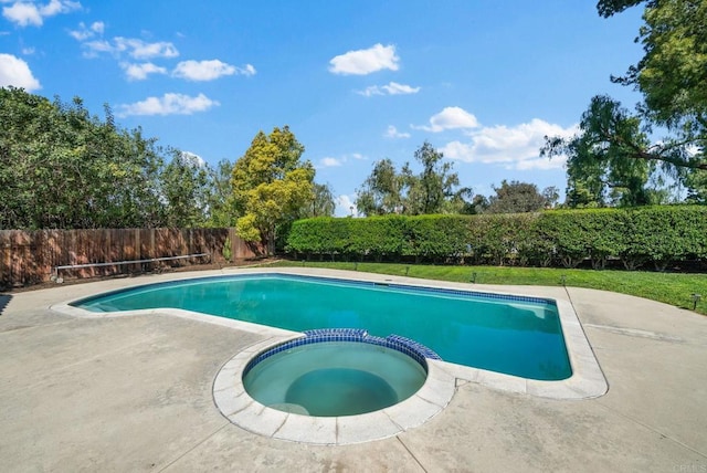 view of swimming pool featuring a fenced backyard, a patio area, and a pool with connected hot tub
