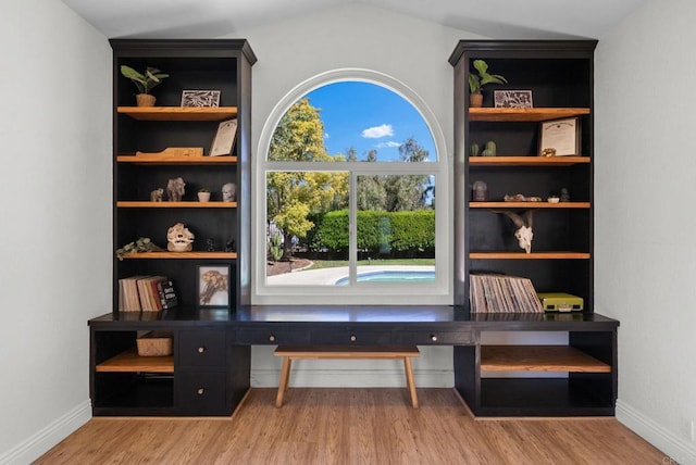interior space with baseboards and wood finished floors
