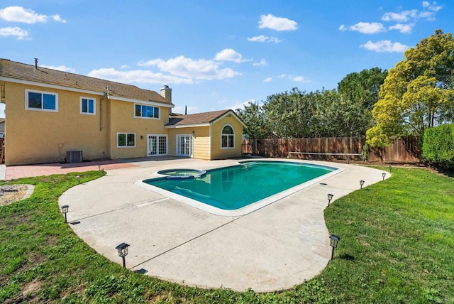 view of pool with a lawn, an in ground hot tub, a fenced backyard, and a patio area