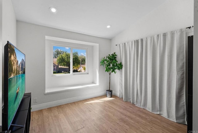unfurnished room with baseboards, recessed lighting, wood finished floors, and lofted ceiling